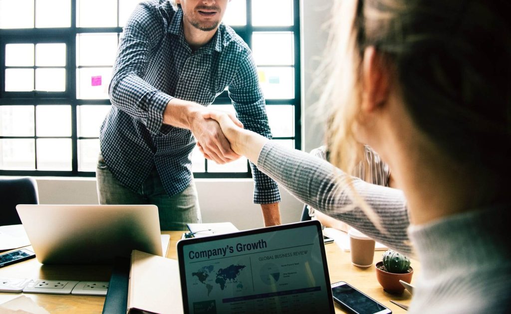 A man shaking a womans hand