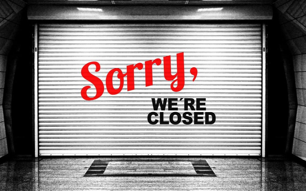 sorry we're closed written on a garage door