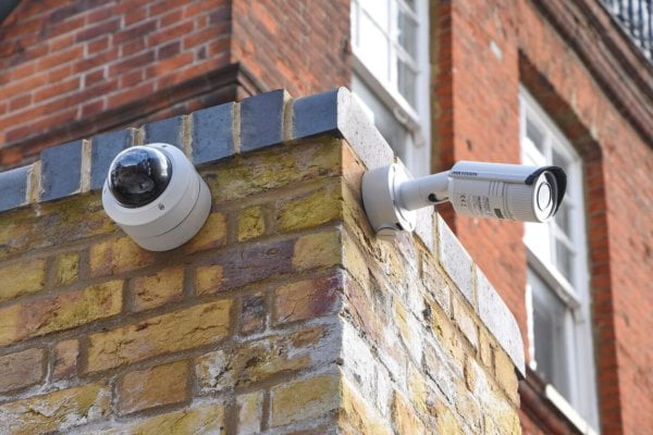 two security cameras on the exterior of a building