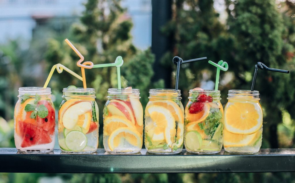 different jars of drinks lined up next to each other