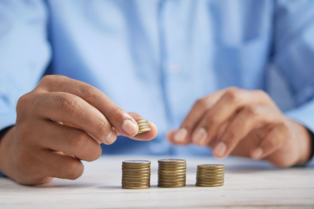man saving money to represent how to reduce energy costs
