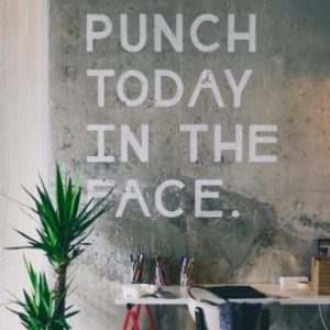 printed wall graphics saying punch today in the face to boost office morale