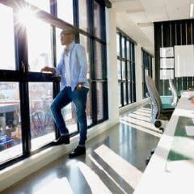 man standing by an office window